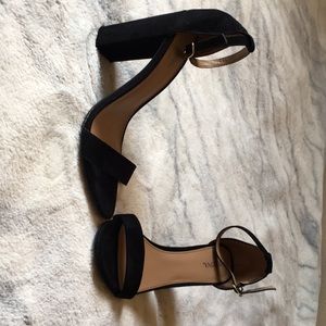 Black ankle strap heels.